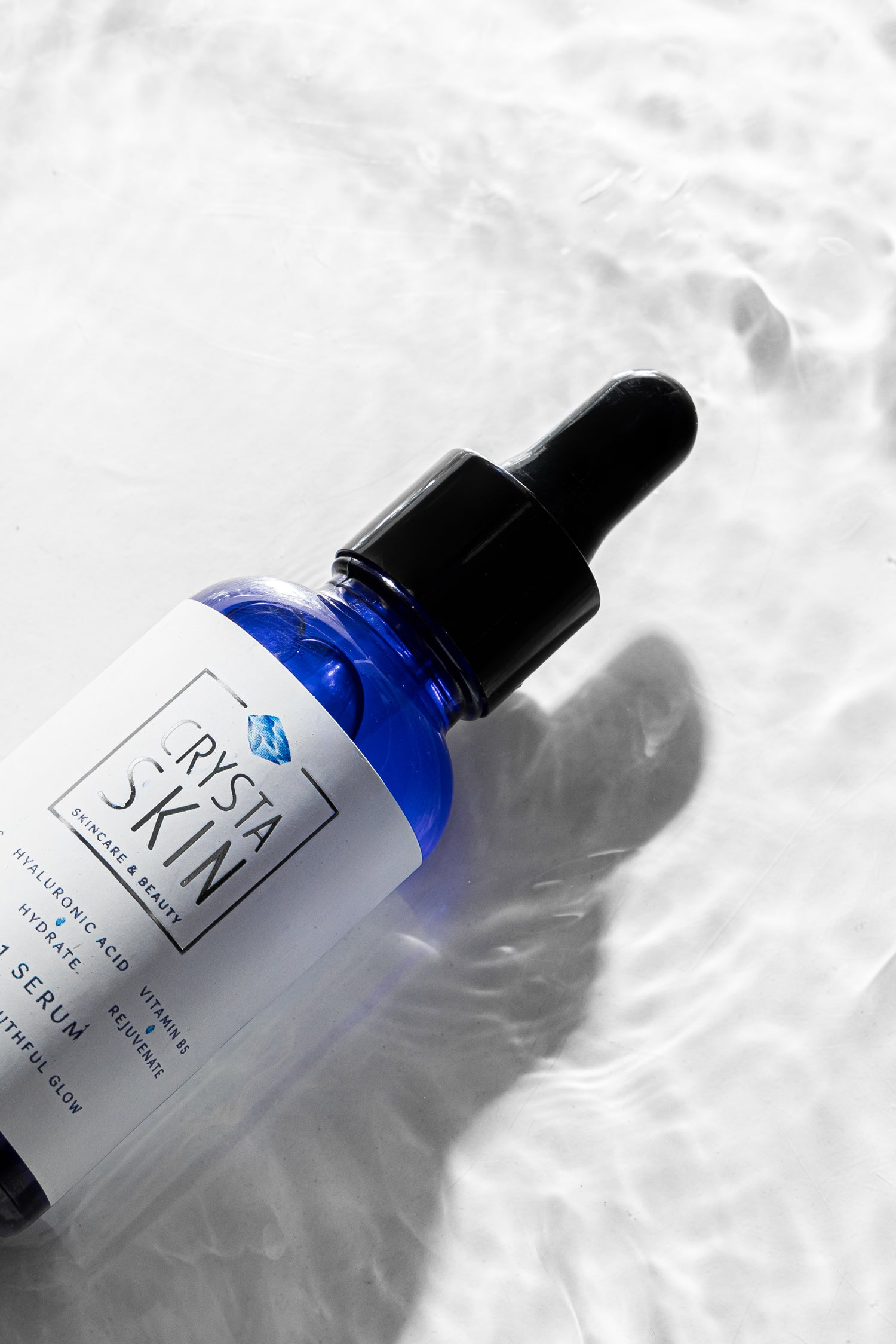 Vitamin C face serum bottle
Hyaluronic acid serum texture
Crysta Skin face serum application